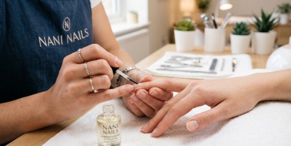 Manicurist applying cuticle 202604281410